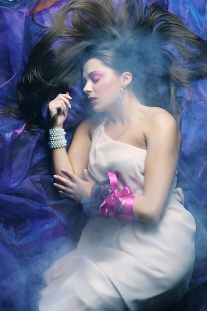 Beautiful woman lay on organza Sleeping beauty