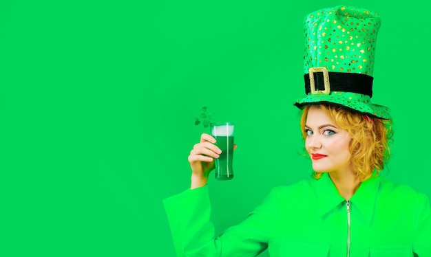 Beautiful woman in leprechaun hat with green beer saint\
patricks day celebration irish traditions
