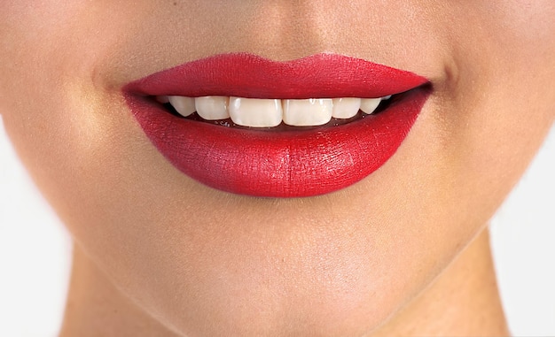 Beautiful woman lips with red lipstick Smiling mouth with white teeth