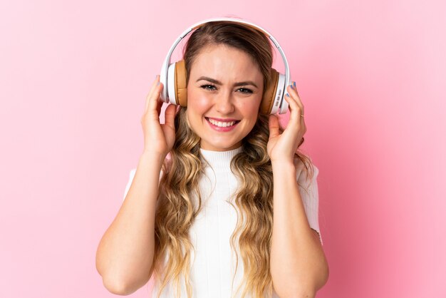 Beautiful woman listening to music in headphones