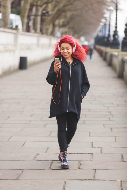 Beautiful woman listening music in London