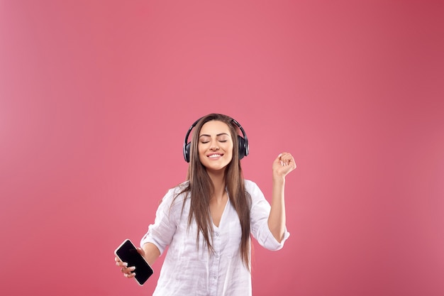 Beautiful woman listening to music using wireless headphones