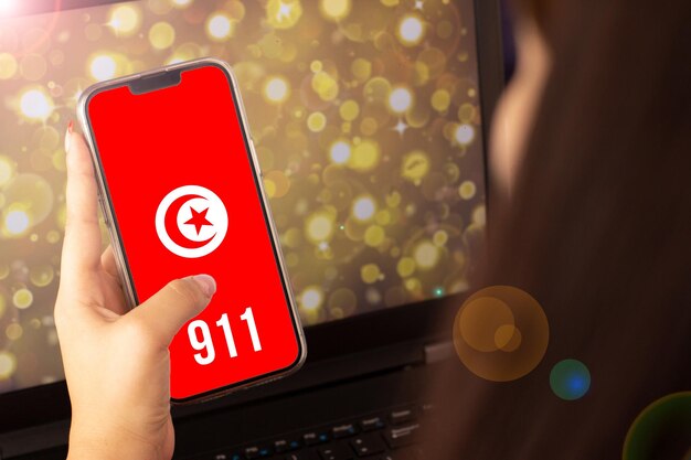Beautiful woman living on the cell phone the flag of turkey with the numbers 911 at the bottom