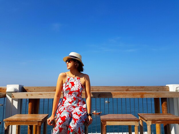 Beautiful woman looking away against sky