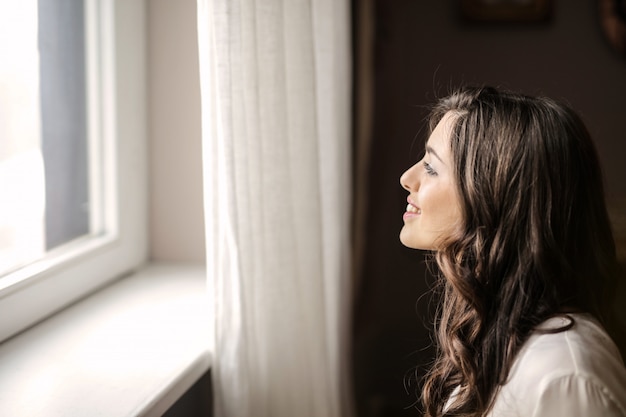 Beautiful woman looking out of the window