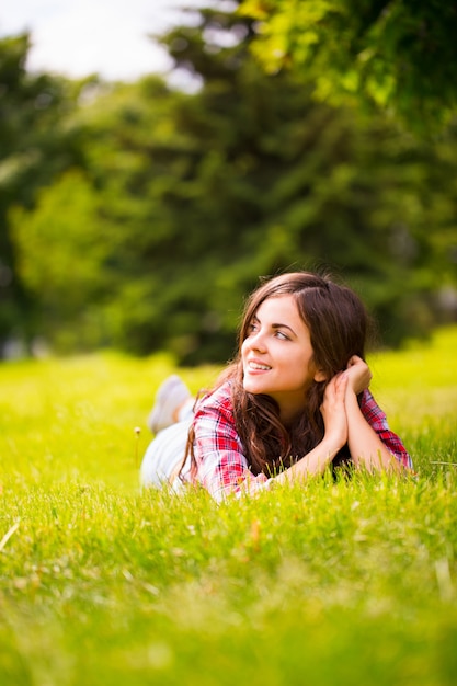 Beautiful woman lying on green grass