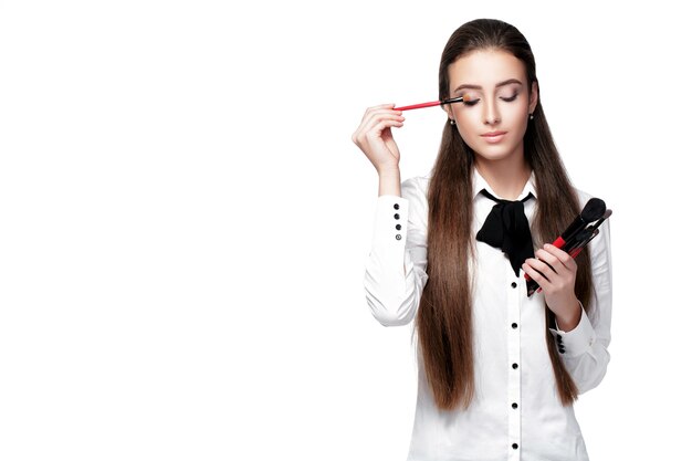 beautiful woman make-up artist with natural make-up holding makeup brush on white background