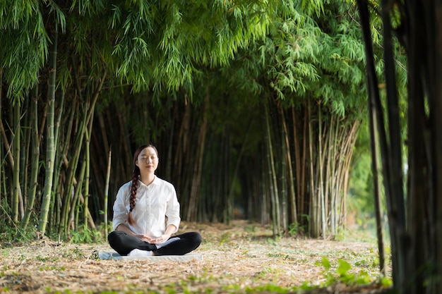 Beautiful woman meditating in nature