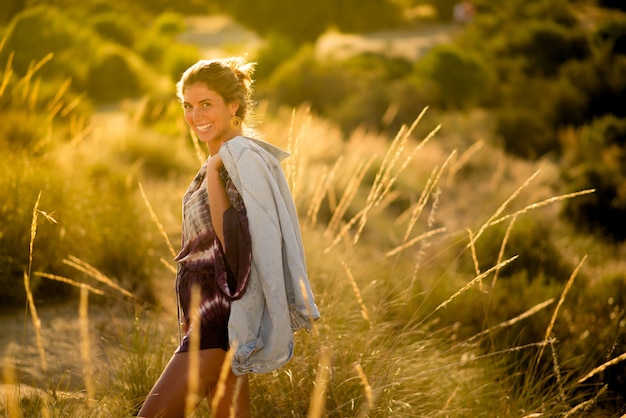 Beautiful woman outdoors enjoying spring in nature.