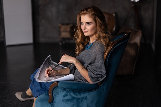 Beautiful woman painting in her studio