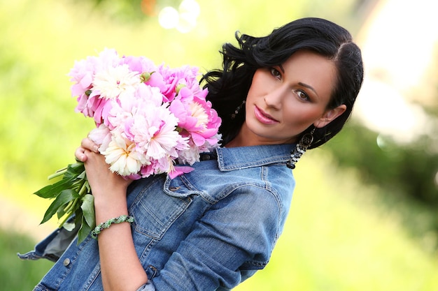 Beautiful woman in a park with bouquet