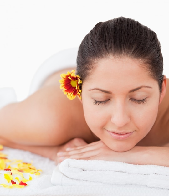 beautiful woman peacefully smilling surrounded by flower petals