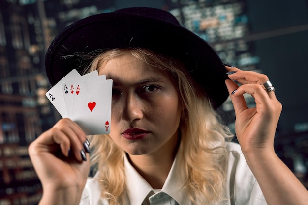 beautiful woman player plays poker and looks at cards and chips casino poker game excitement