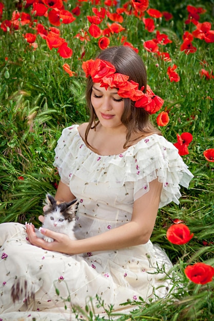 Beautiful woman plays with a kitten