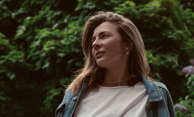 Beautiful woman portrait on the background of the park