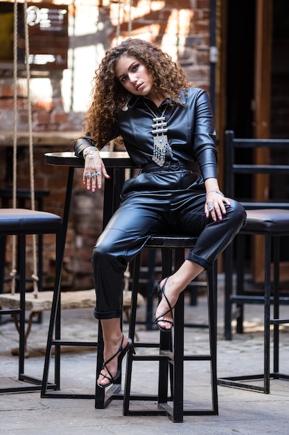 beautiful woman posing in leather clothes