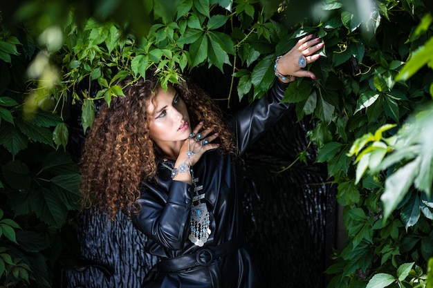 Beautiful woman posing in leather clothes