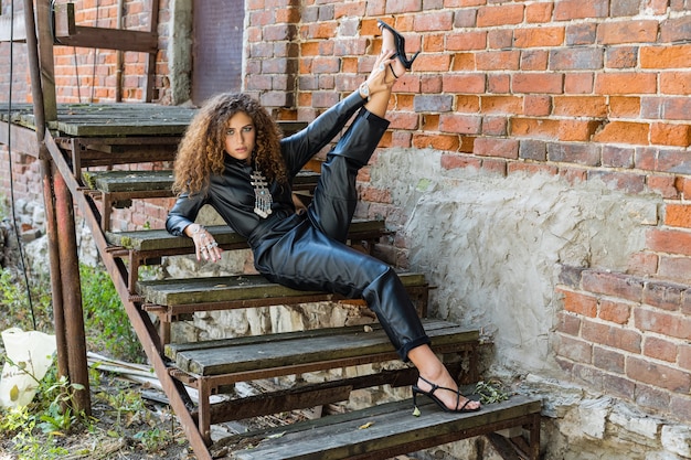 Beautiful woman posing in leather clothes