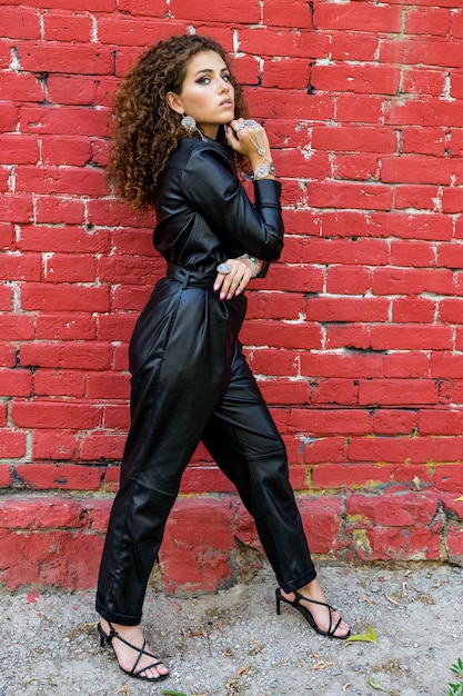 Beautiful woman posing in leather clothes