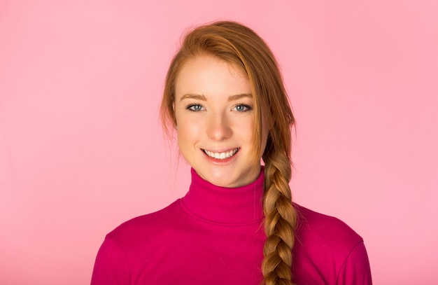 Beautiful woman posing on pink wall