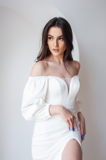 The beautiful woman posing in a wedding dress