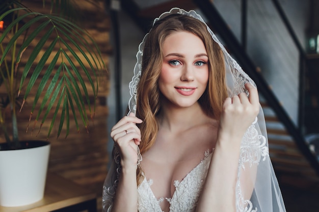 The beautiful woman posing in a wedding dress