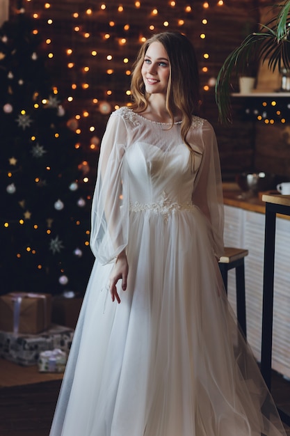 The beautiful woman posing in a wedding dress.