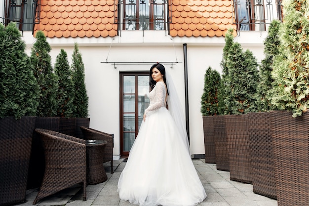 The beautiful woman posing in a wedding dress