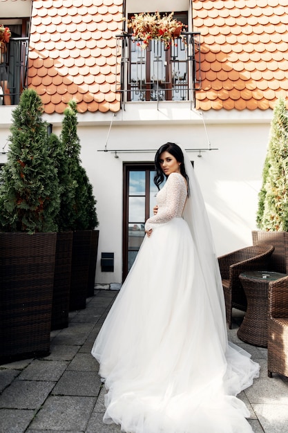 The beautiful woman posing in a wedding dress