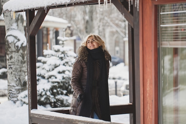 Beautiful woman posing in the wintertime in the city