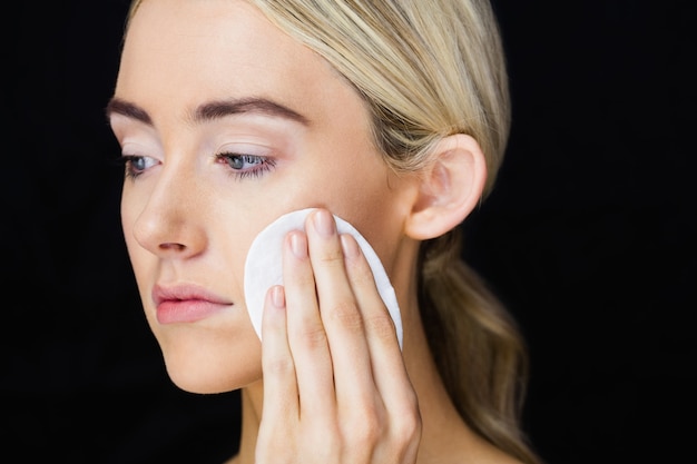 Beautiful woman putting makeup