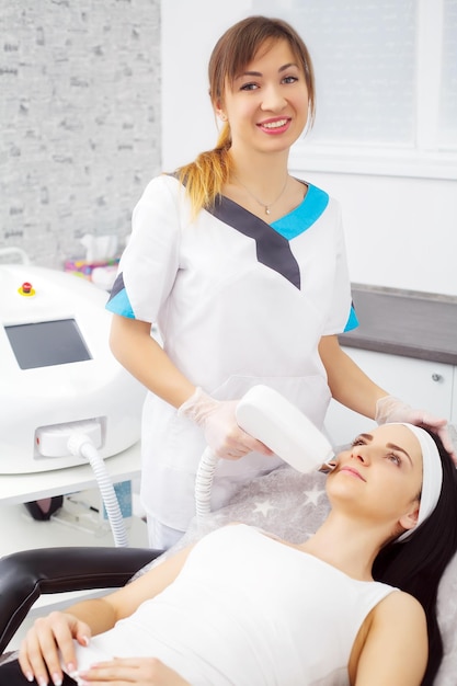 Beautiful woman receiving a laser hair removal procedure.