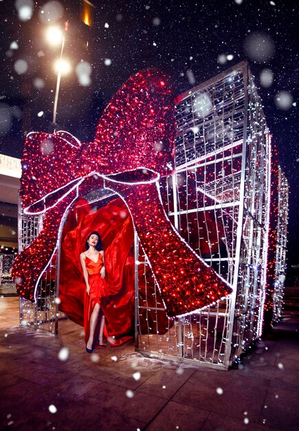 Beautiful woman in red dress in christmas decor