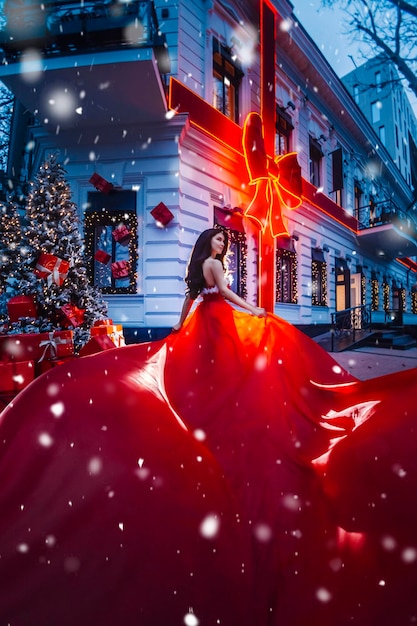 Beautiful woman in red dress in christmas