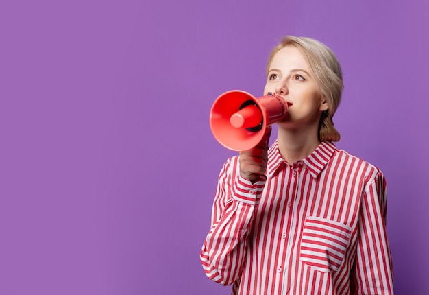 Beautiful woman in red striped shirt with megaphone  