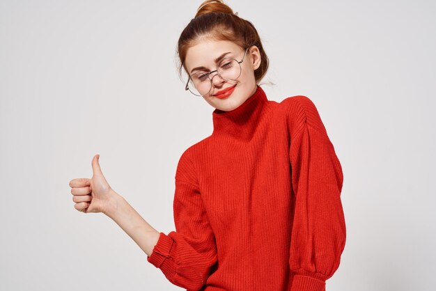 Beautiful woman in a red sweater Lifestyle light background High quality photo