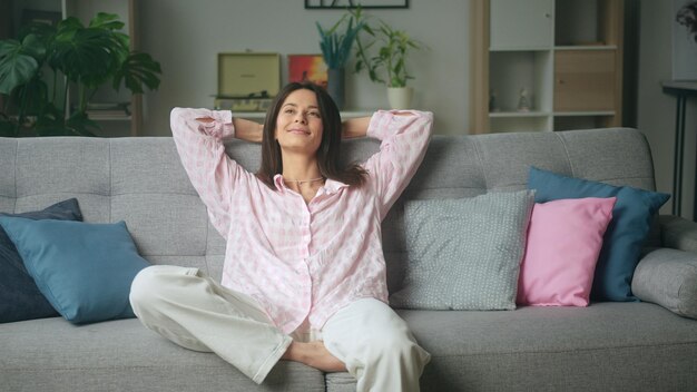 beautiful woman relaxing on comfortable sofa at home