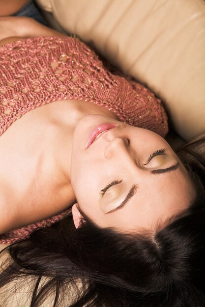 Beautiful woman relaxing on a white sofa