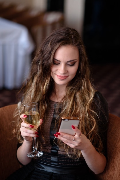 Beautiful woman in a restaurant communicates by phone