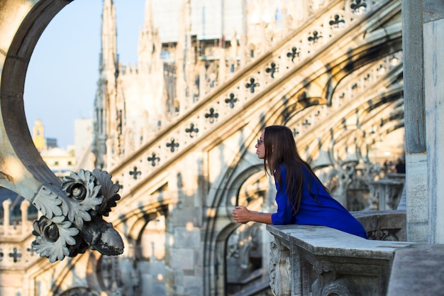 Beautiful woman on on the rooftop of Duomo, Milan, Italy