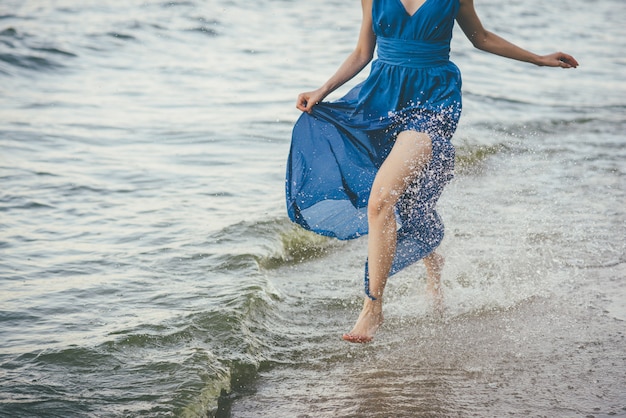 Beautiful woman running along the water's edge.