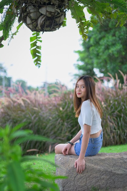 Beautiful woman seats in the park