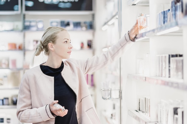 Beautiful woman shopping in beauty store