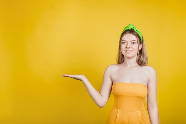 Beautiful woman showing a product in her hands