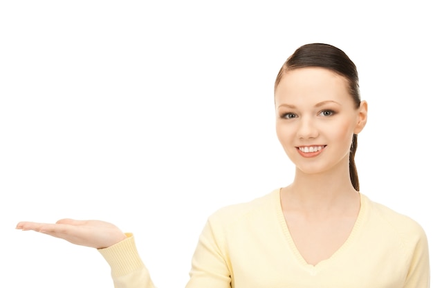 beautiful woman showing something on the palm of her hand