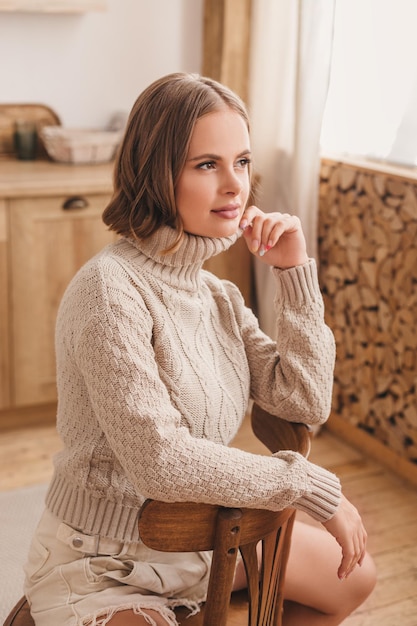 beautiful woman sit in the kitchen and smile