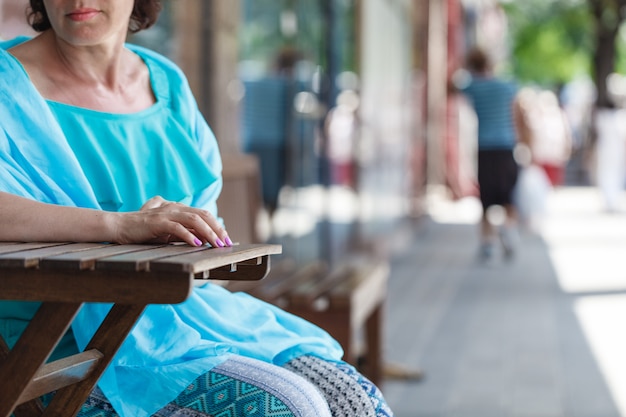 Beautiful woman sitting alone in street cafe