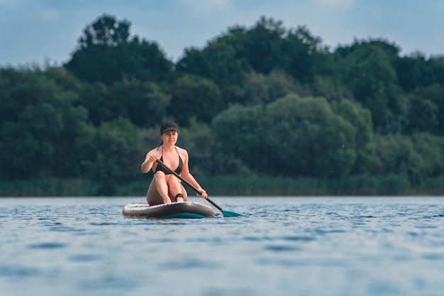 Beautiful woman sitting down on the supboard