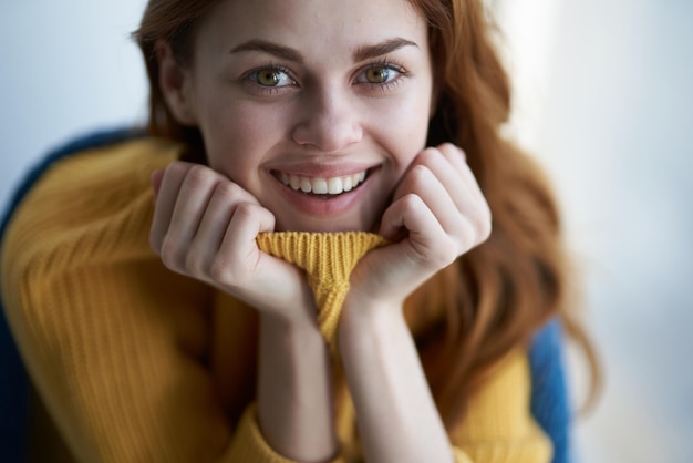 beautiful woman sitting near the window with a blue plaid dreamy look High quality photo