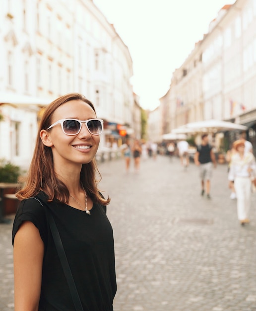 Beautiful Woman Smiling Tourist on Background of European Old Town Street of Ljubljana Slovenia